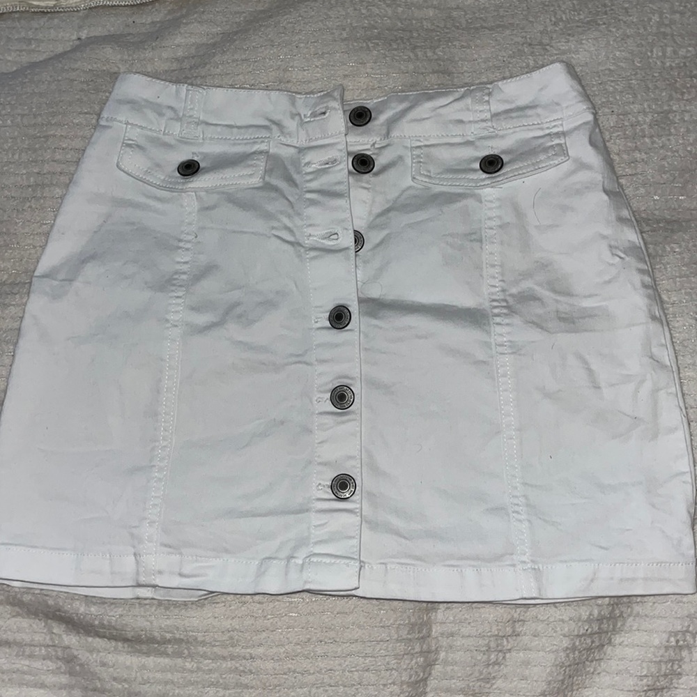 white skirt with silver buttons